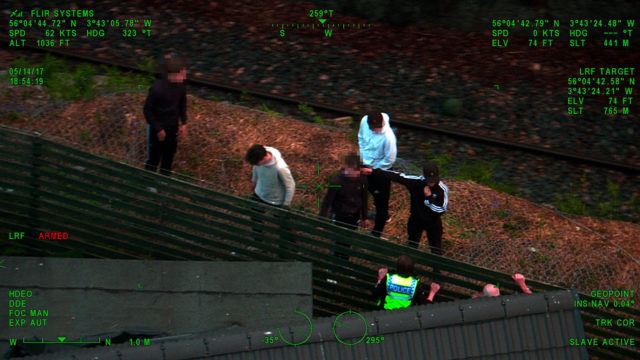 Camera footage of police speaking to youths on the railway