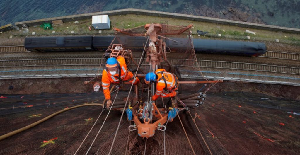 Working to stabalise the cliff face high above the railway 