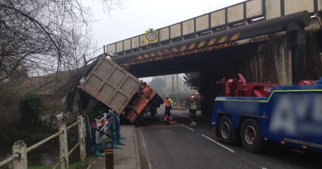 A lorry on it's side after hitting a bridge
