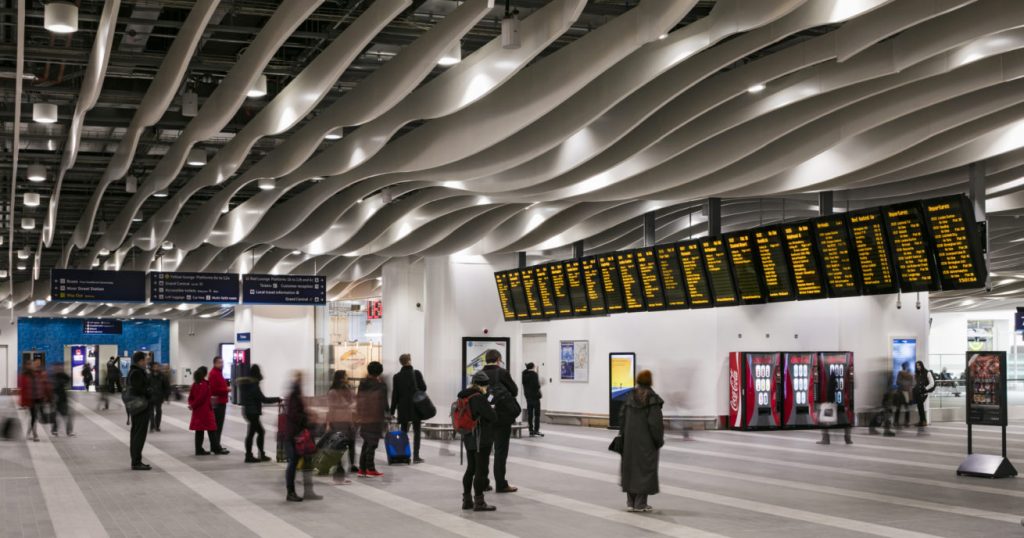 Passengers looking at notice boards at Birmingham New Street