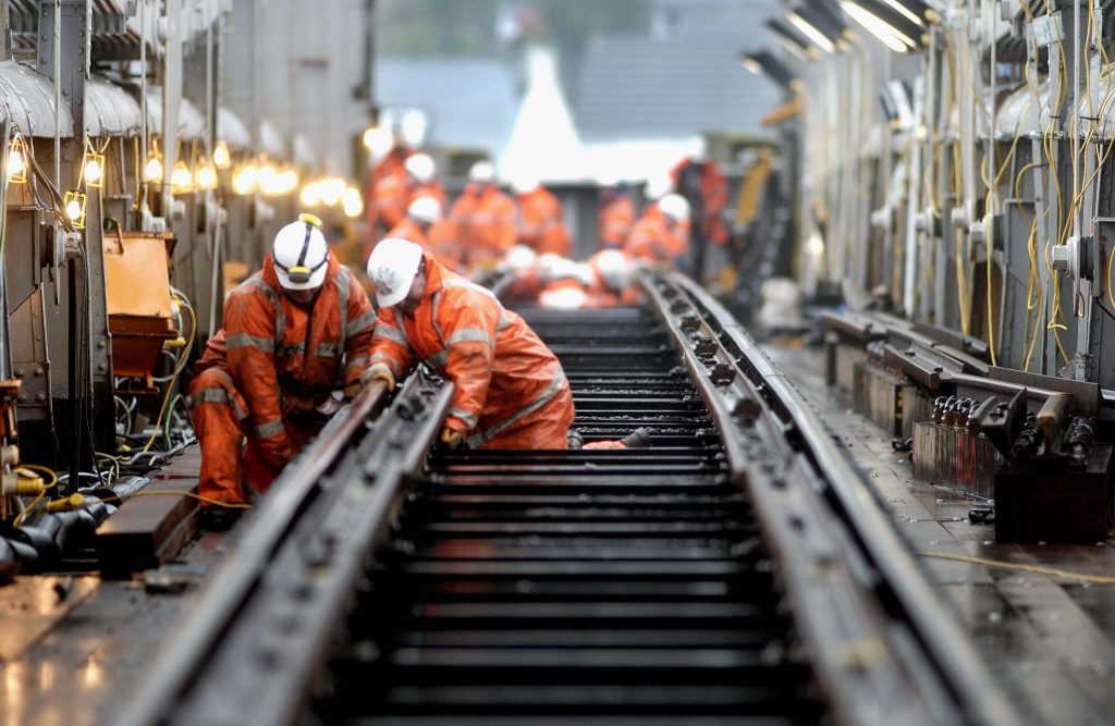 Engineers working on track over bridge