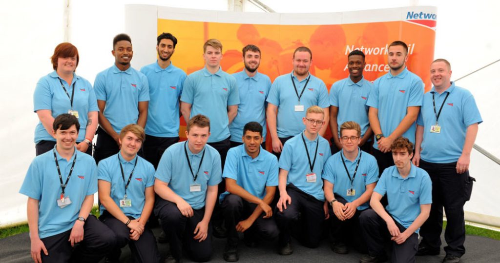 A class photo of apprentices in blue polo shirts at Westwood training centre