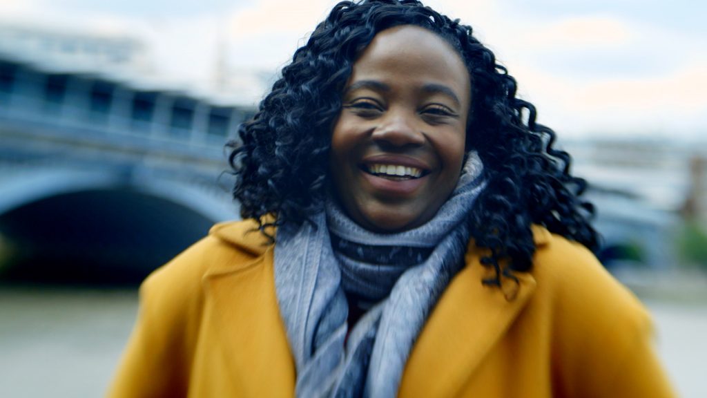 Emily Pollard, an asset engineer, with Blackfriars railway station behind her.