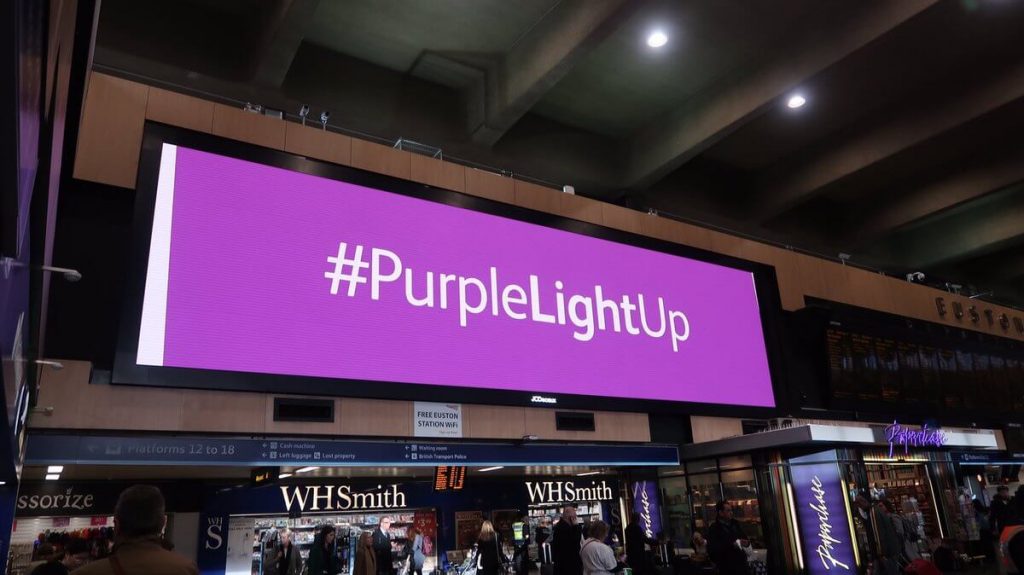 Purple light up sign at London Euston station