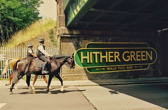 Two police officers on horseback going past theHither Green mural