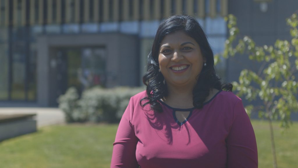 Kamini Edgley, engineer, stands outside one of our Rail Operating Centres, daytime