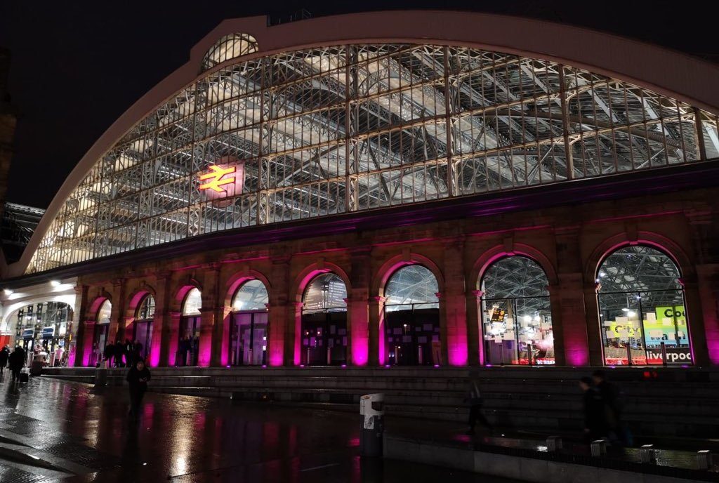 The entrance to Liverpool Lime street lit purple
