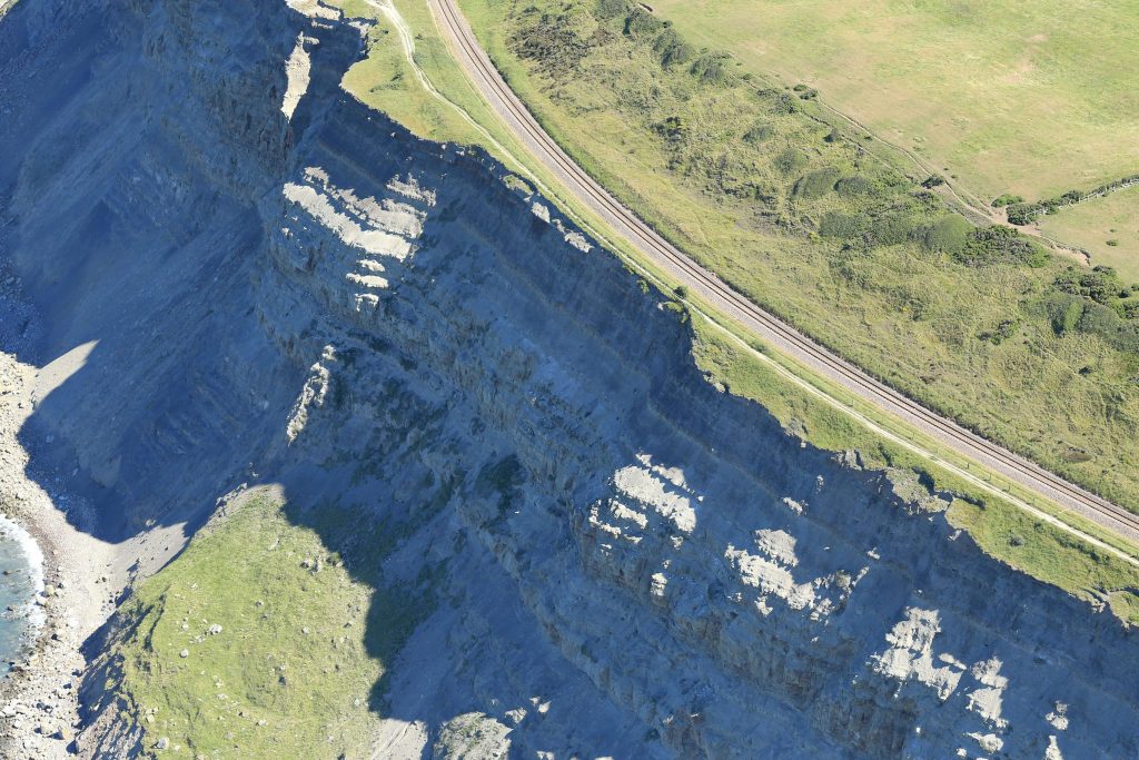 Aerial image of the railway beside cliff erosion
