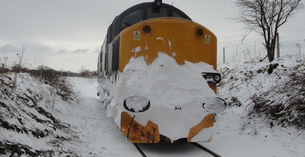 Snow plough moving snow on track