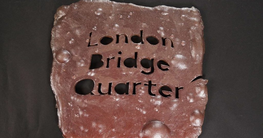Artwork created from ancient clay by artist Alison Cooke with the words "London Bridge quarter" etched into the clay