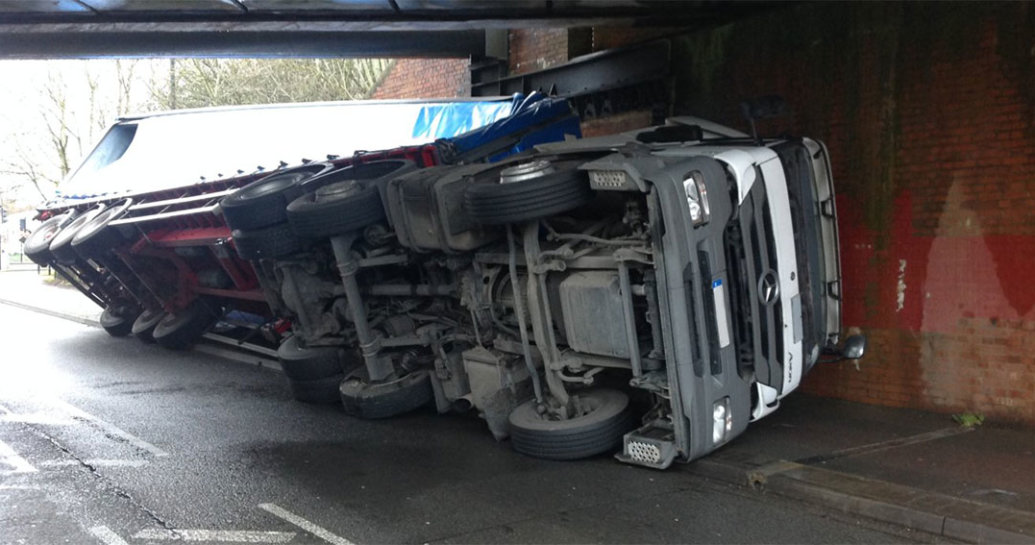 A lorry turned on it's side after crashing into a bridge