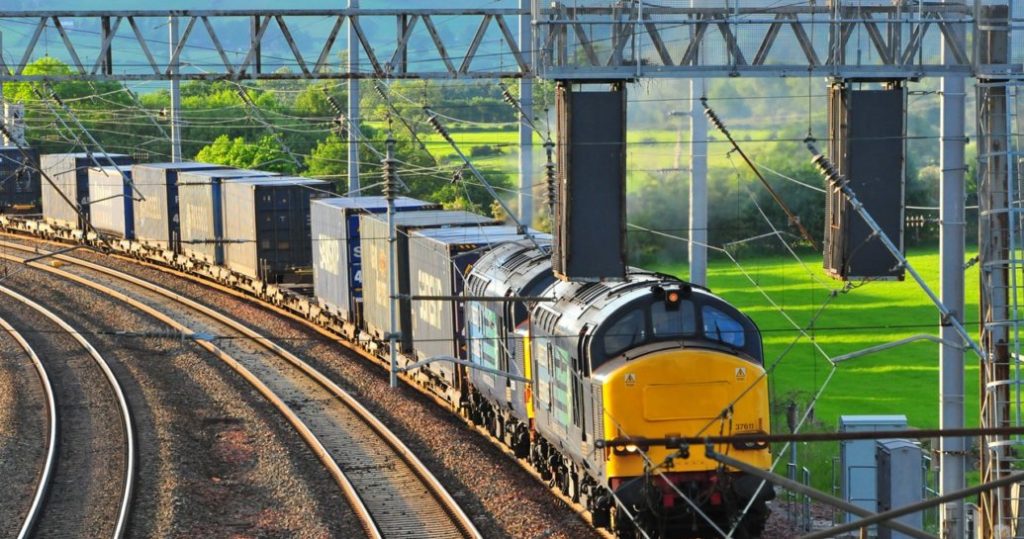 Freight train travelling under over head line equipment