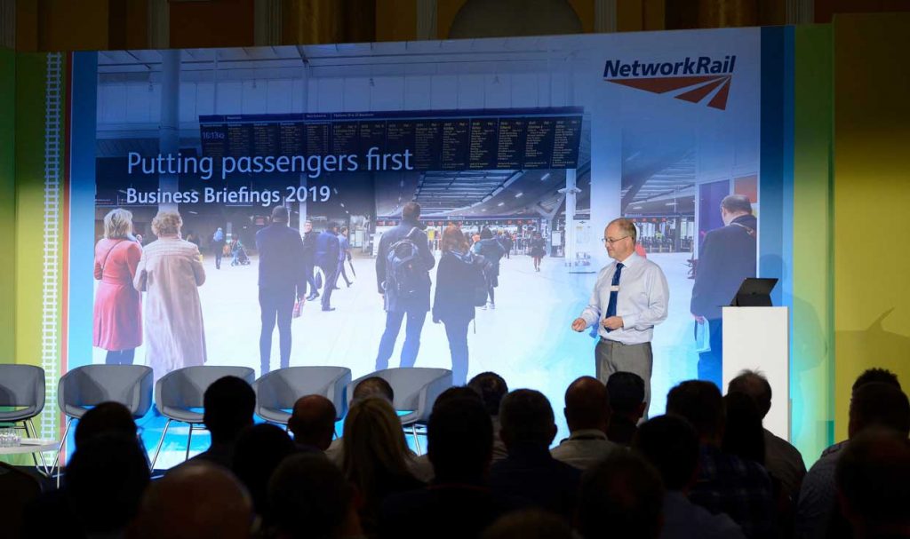 Andrew Haines on stage at a Business Briefing in Cardiff, 2019