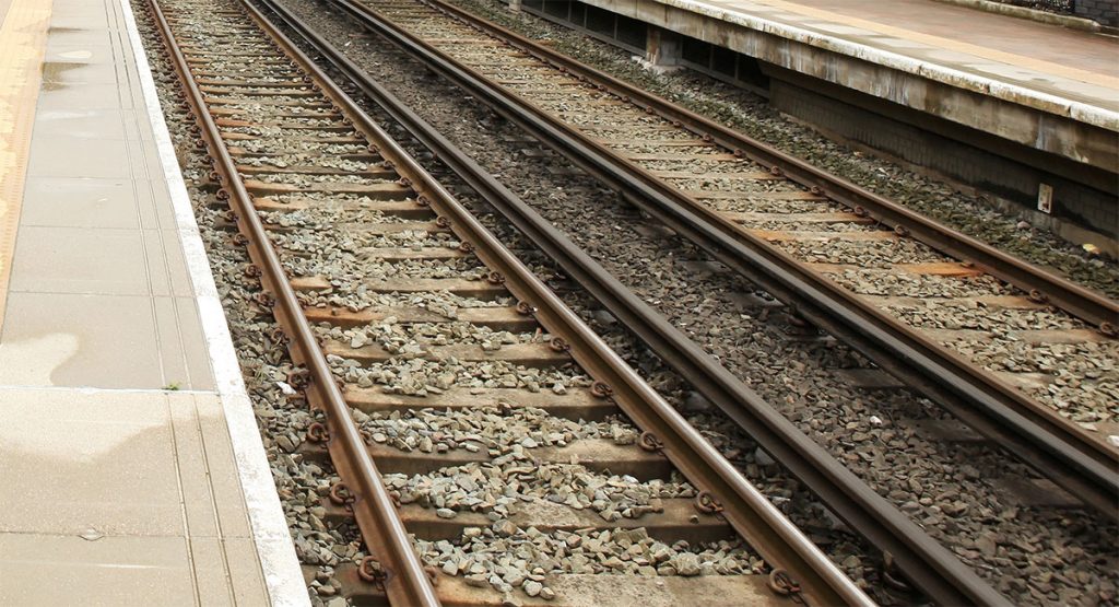 Section of railway showing the third rail, which are darker raised rails in between standard tracks