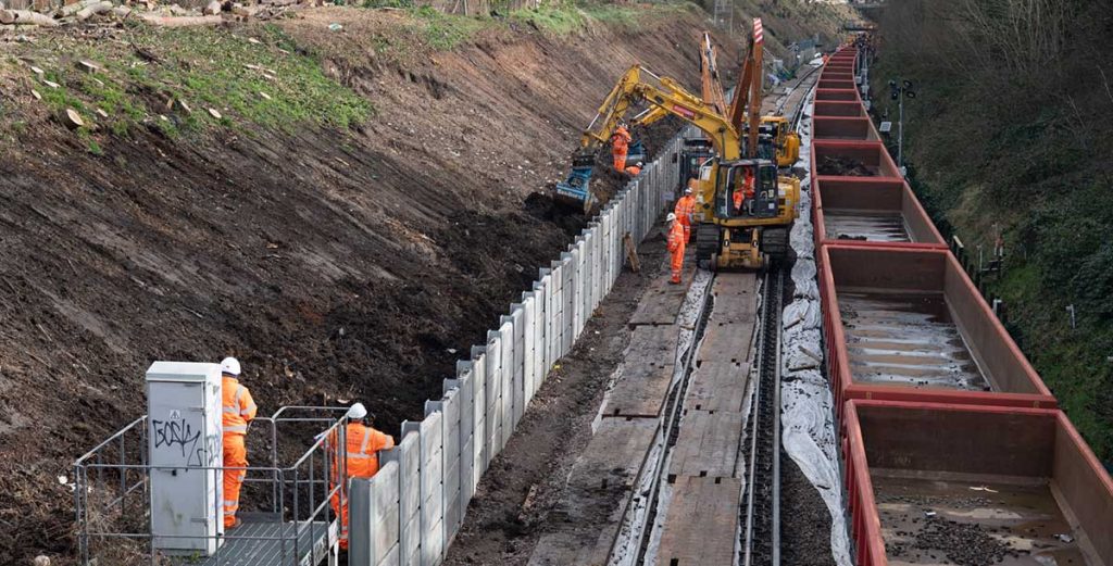 Workers digging out embankment