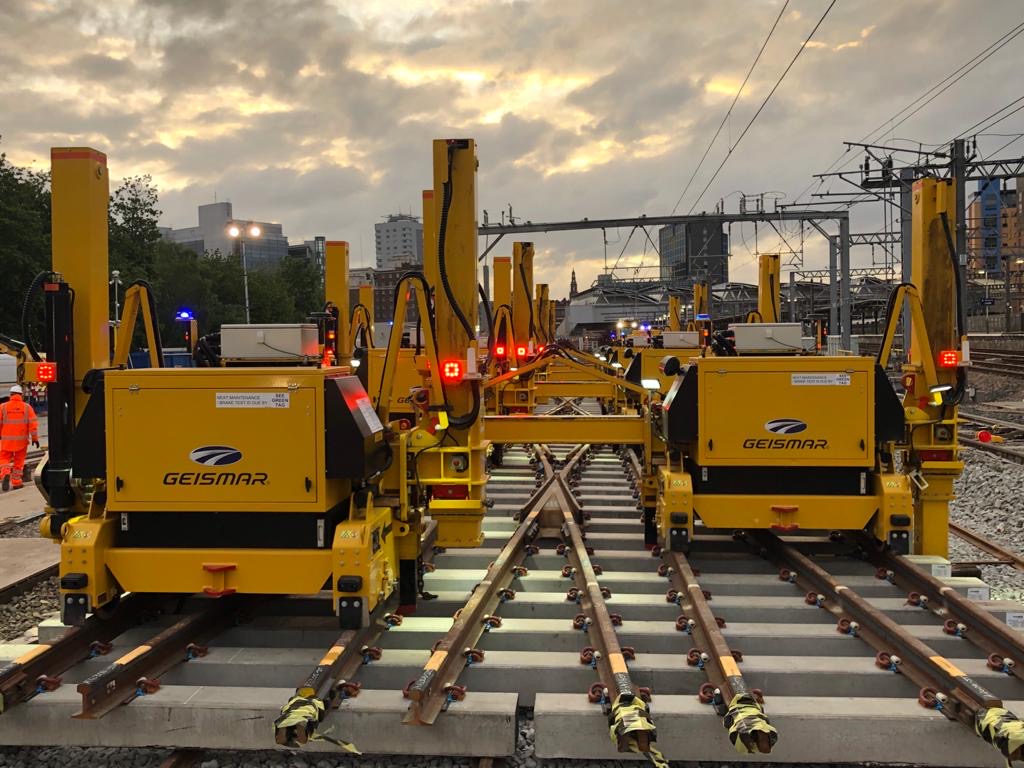 Specialist yellow machinery on the railway tracks, dusk