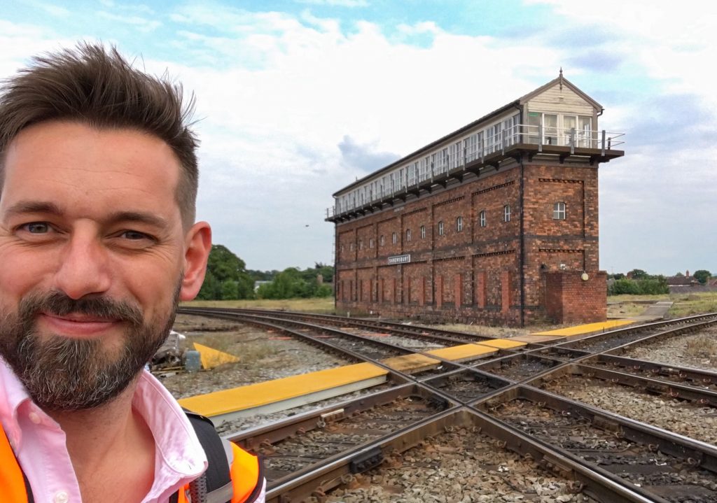 Tim Dunn, presenter of The Architecture the Railways Built standing outside the Severn Bridge Junction signal box