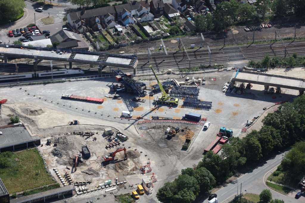 Aerial view of a large crane lifting hundreds of tonnes of concrete