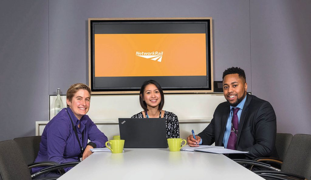 Network Rail staff members sat at an office table