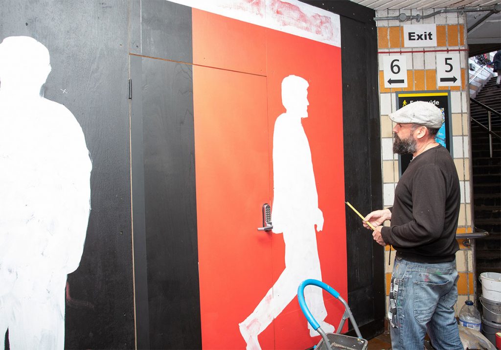 Lionel Stanhope, artist, painting a mural in the underpass at Charing Cross station