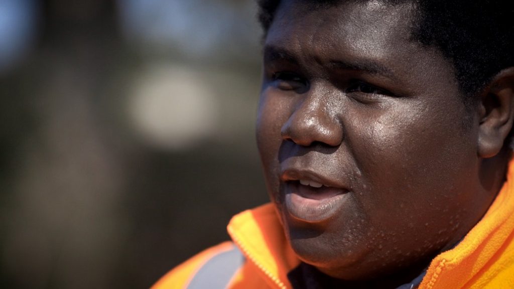 Close up still from a film of Nathaniel, a Network Rail ecoligist