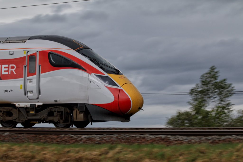 Side shot of an Azuma train travelling fast, daytime