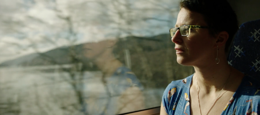 Railway worker and ice swimmer Jade Perry looks out of a train window in Scotland