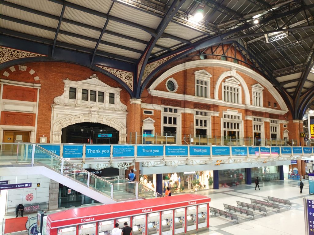 Inside London Liverpool Street station with ticket machines in foreground