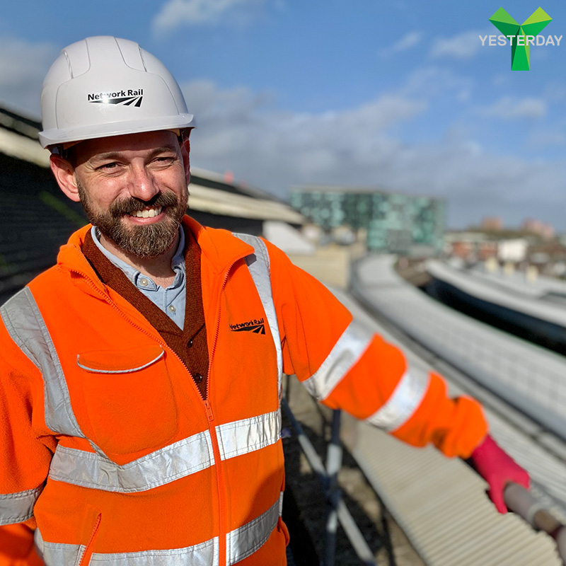Presenter Tim Dunn in PPE and hard hat on top of Bristol Temple Meads station roof