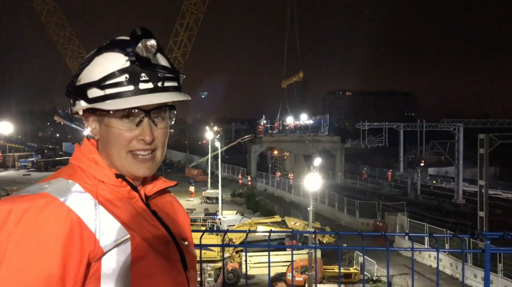 Engineer Tara Scott in PPE at the Bletchley flyover, watching it being taken apart, nighttime
