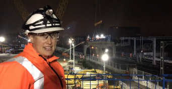 Engineer Tara Scott in PPE at the Bletchley flyover, watching it being taken apart, nighttime