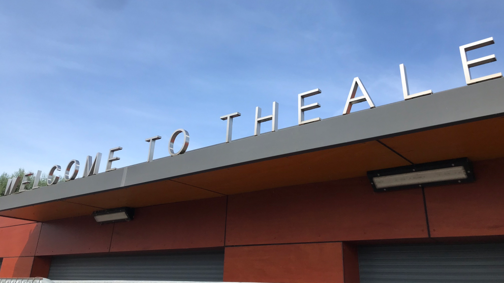 Station sign at Theale railway station near Reading on a clear day