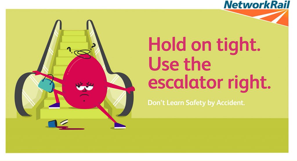 A cartoon poster of a character who has slipped over at the bottom of an escalator. The copy on the poster says "Hold on tight. Use the escalator right. Don't learn safety by accident"