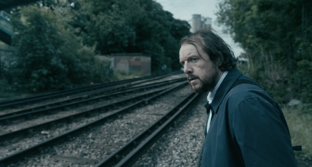 Shattered Lives film still - man trespassing on a railway line, daytime