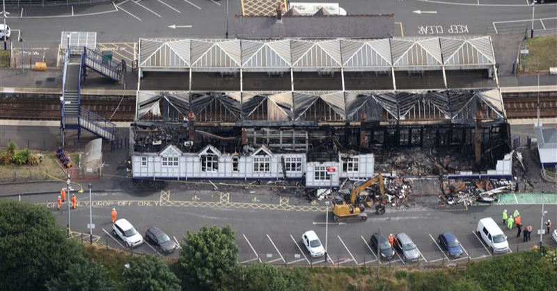 Aerial shot of extensive fire damage at Troon railway station, daytime