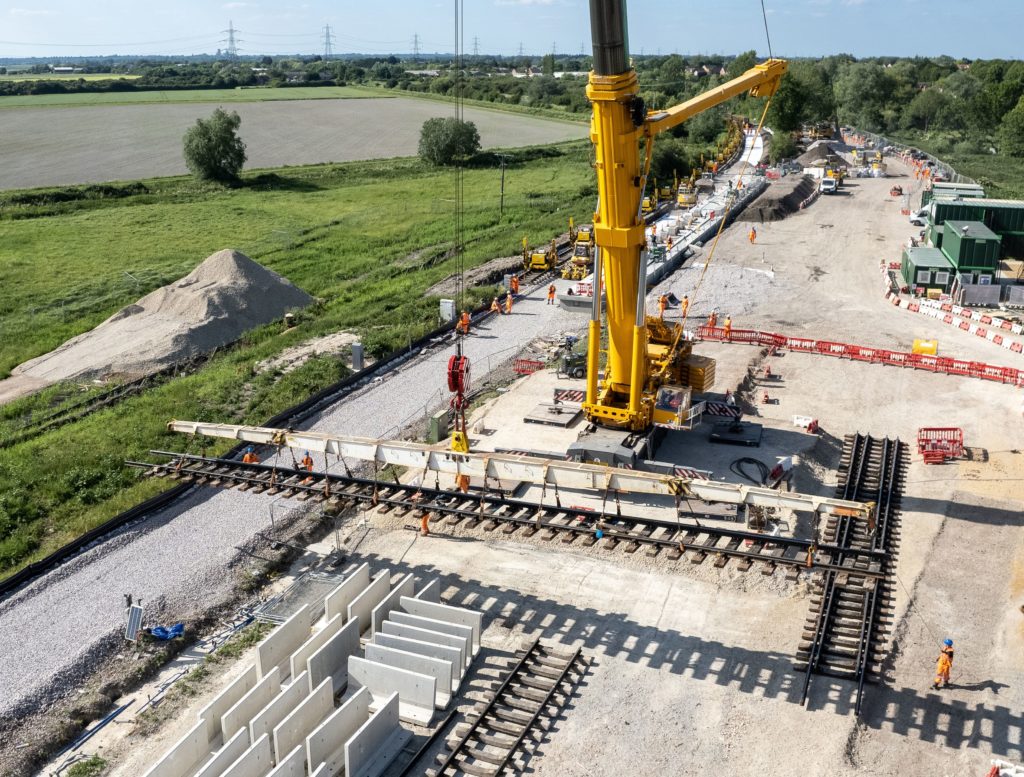 A large yellow crane during works to create a new railway station in Soham, daytime
