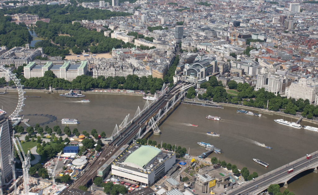 Aerial view of the River Thames with London Charing Cross station, the Hungerford Bridge and Buckingham Palace, daytime