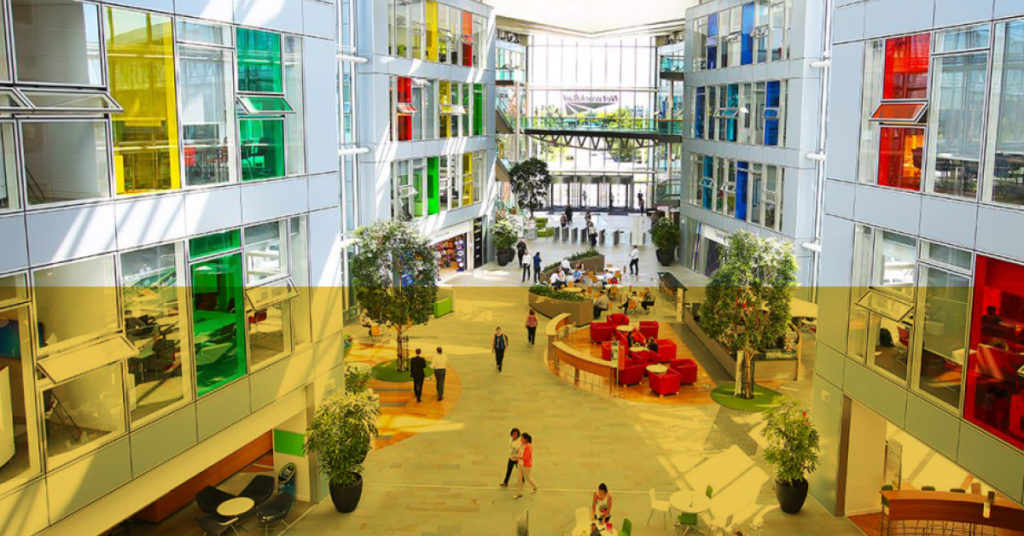 A huge atrium with colourful office windows looking into the centre shows the potential of a career as a property graduate.