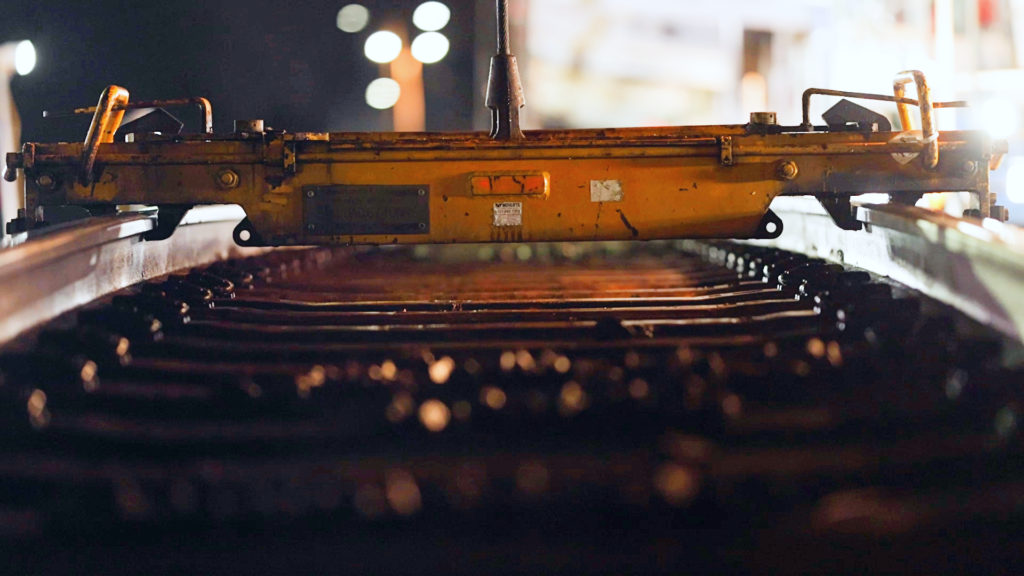 Close up of track removal machine lifting track