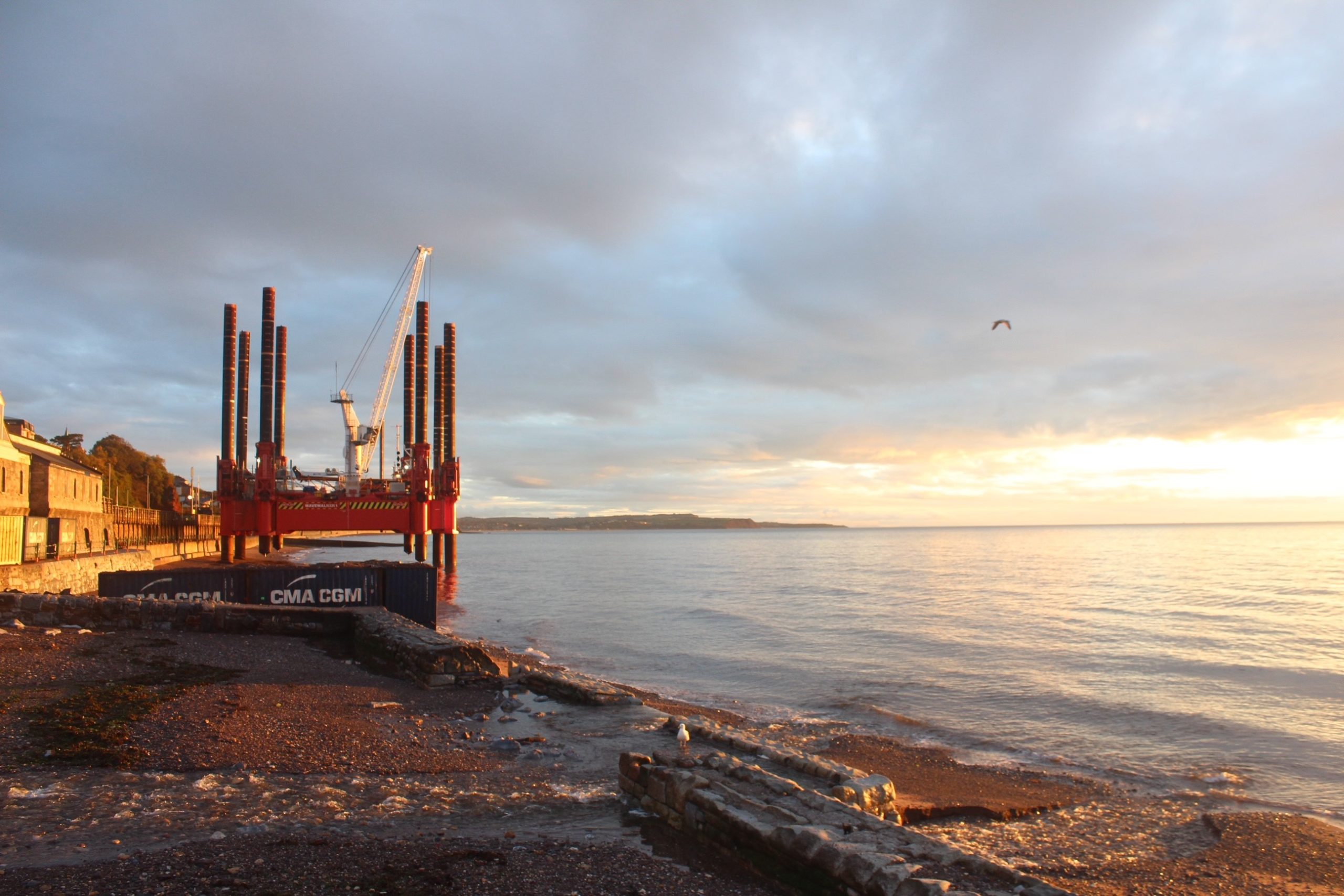 Wavewalker on coast of Dawlish in sunset wide 