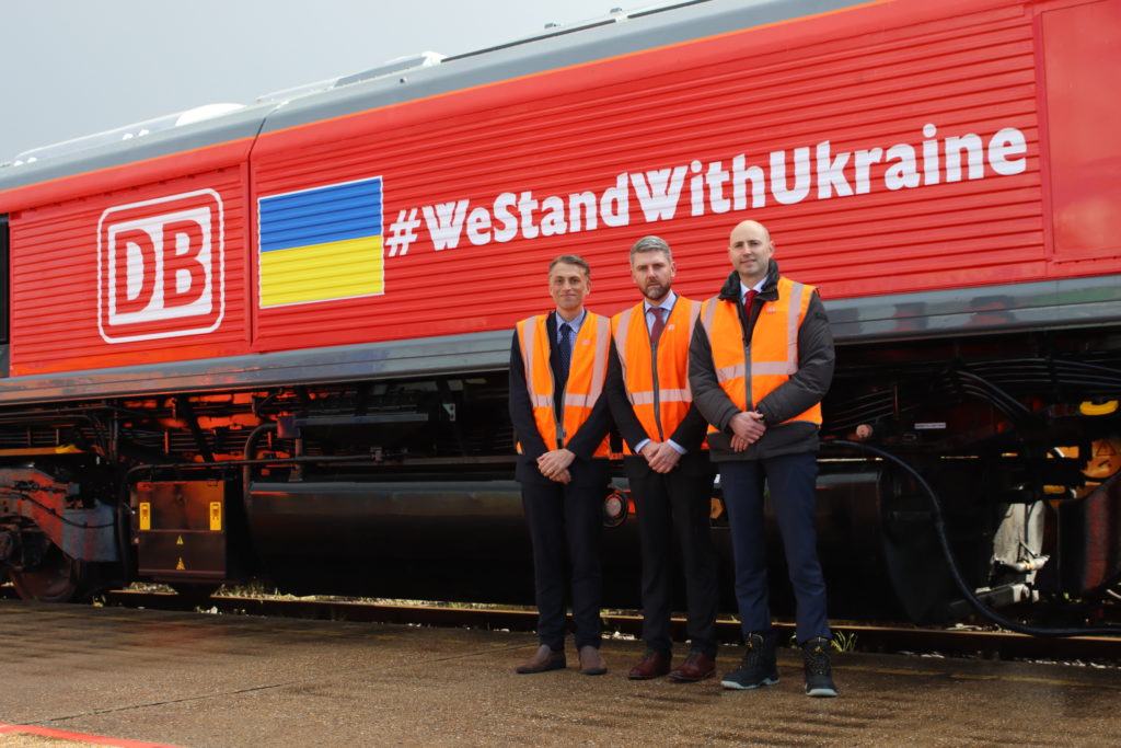DB Cargo colleagues in front of aid freight train for Ukraine
