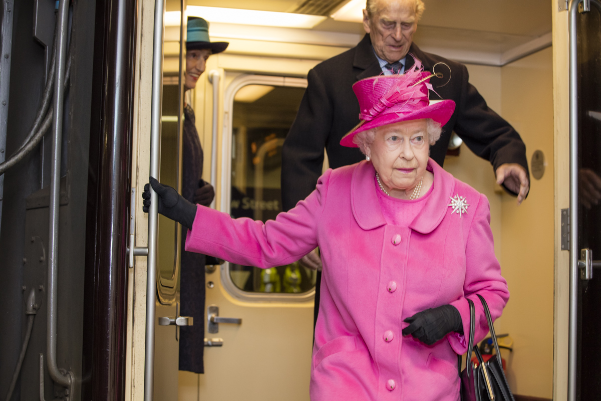 Her Majesty The Queen and His Royal Highness The Duke of Edinburgh disembarking a service Birmingham New Street.