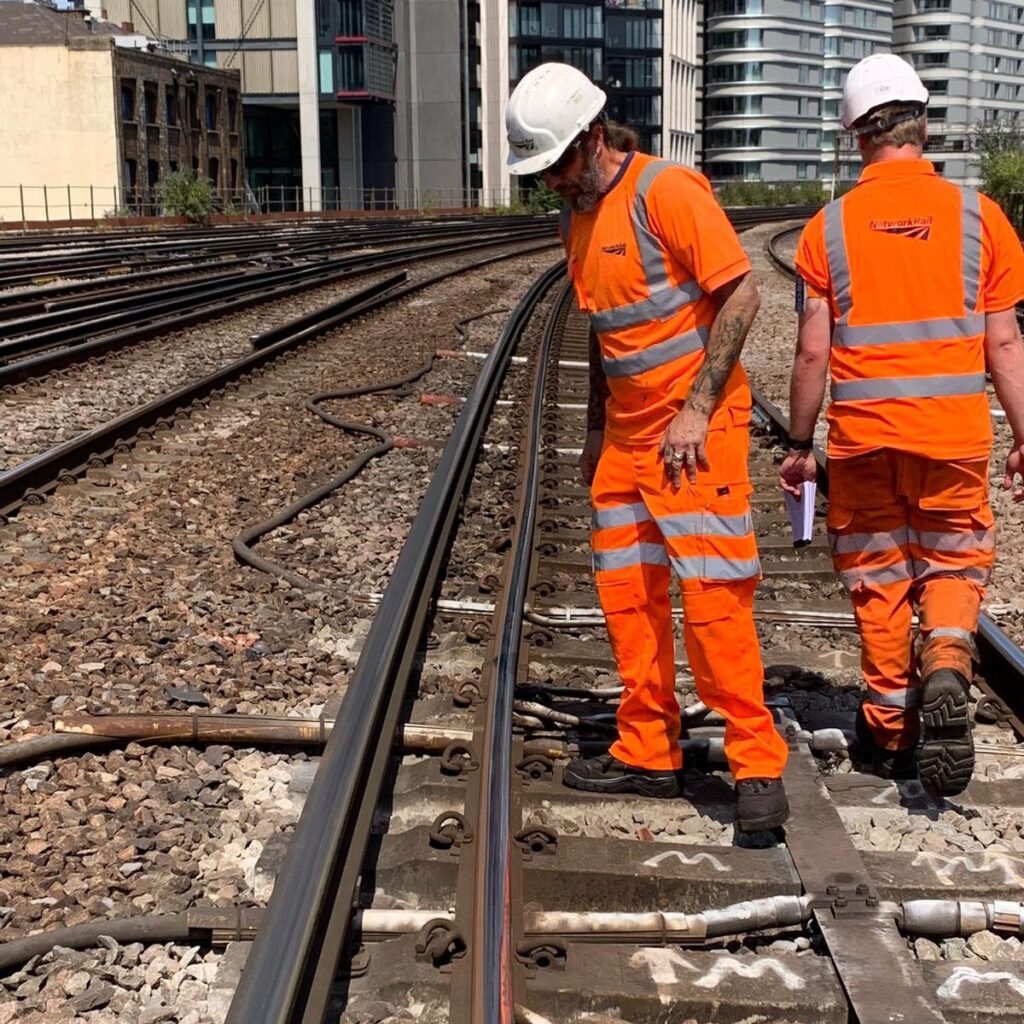 Network engineers inspecting hot rail.