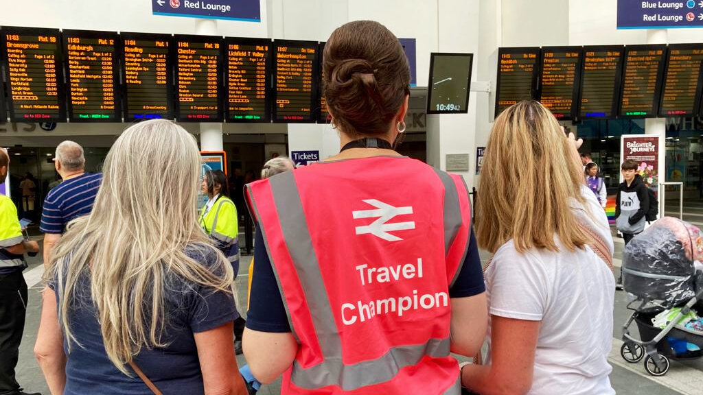 Railway volunteers assisting passengers at Birmingham New Street station.