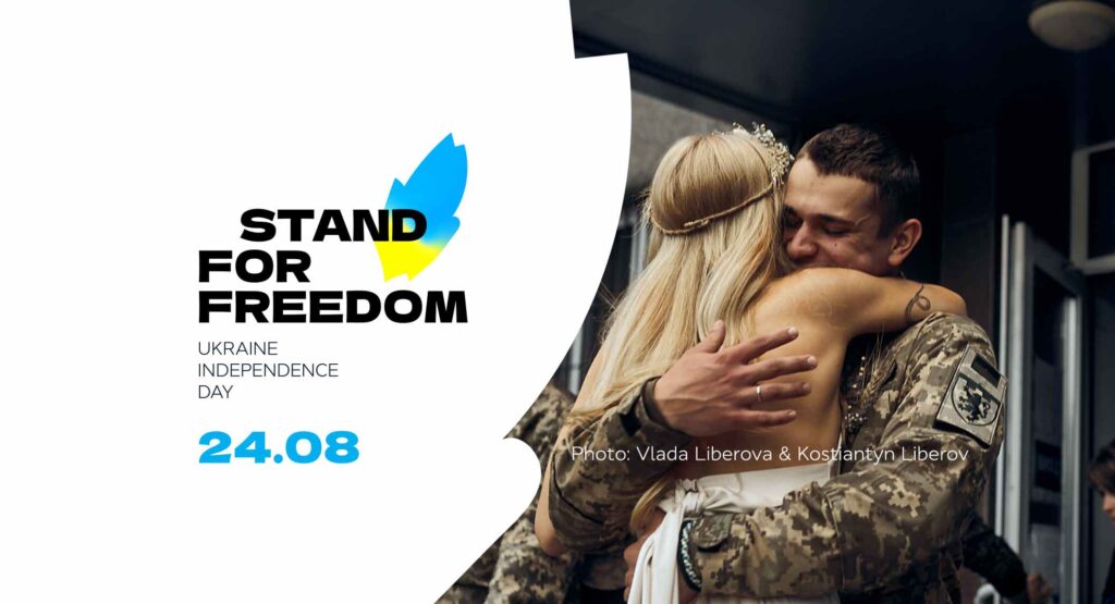 Graphic for Ukraine's Independence Day showing a man and woman embracing, with the main text reading 'stand for freedom'