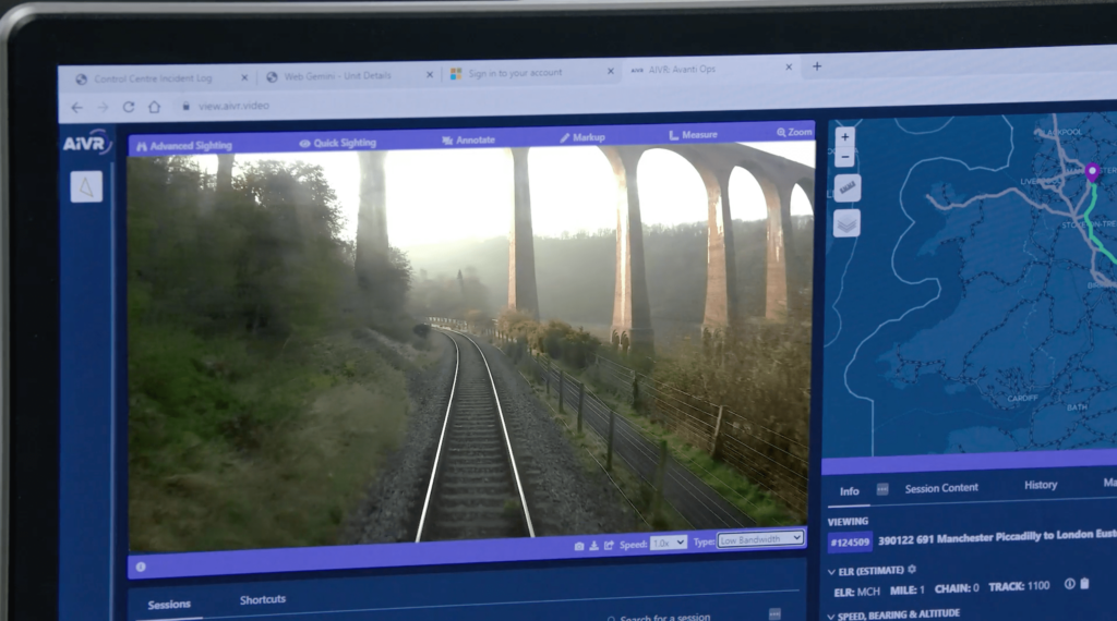 Close-up of a computer screen showing the AIVR technology, featuring footage of a viaduct and a map.