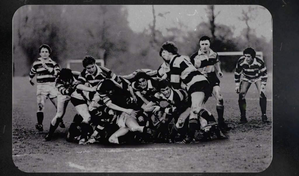 Still of a 3D-animated black and white photograph of Network Rail board member Stephen Duckworth playing rugby at university