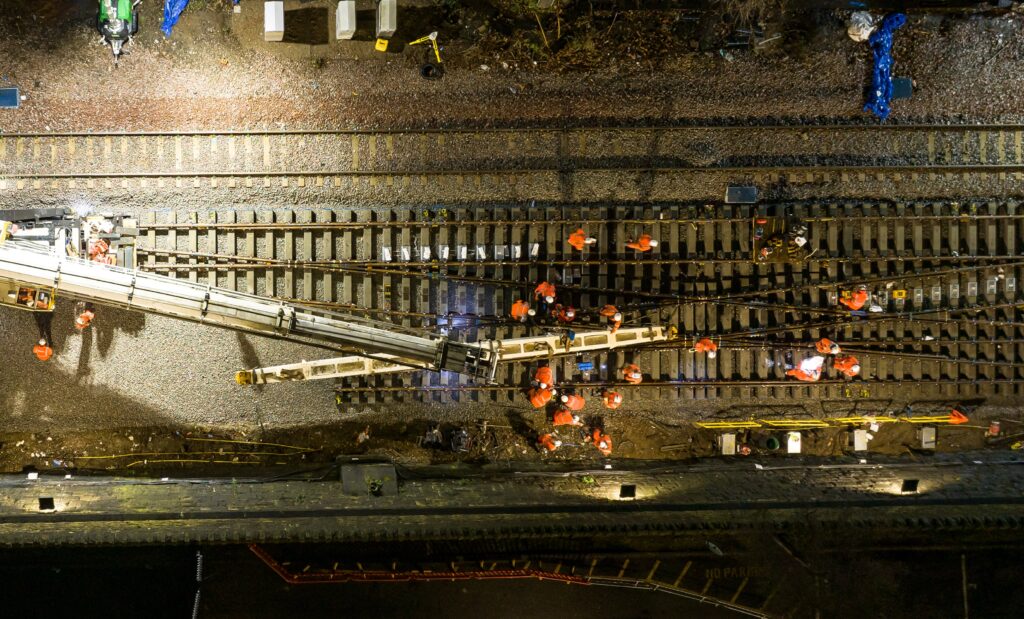 Aerial image of rail workers installing new track at Holbeck near Leeds, nighttime.
