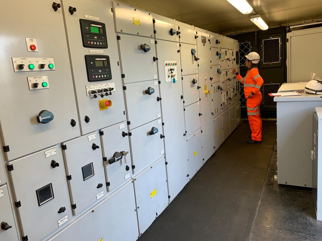 Senior engineer Nilda Sanchez inspects equipment during engineering verification at a principal supply point.