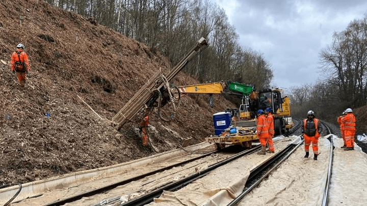 Rail workers working on the embankment between Feltham and Wokingham.